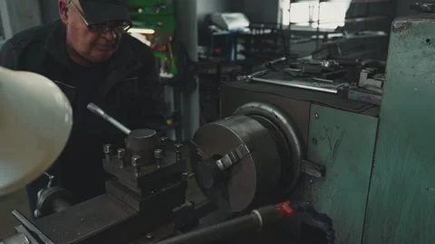 Cinematic portrait of an elderly locksmith working at a lathe Stock Footage 281582642