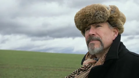 Cinematic portrait of man in nature with dramatic storm clouds in background. Stock Footage 145321839