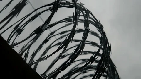 Cinematic Prison Exterior With Barbed Wire High On Fence, Maximum Security Stock Footage 129367365