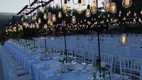 Cinematic pull-away shot of luxury wedding table setting with vintage edison Stock Footage 346568671