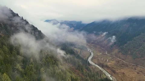 Cinematic pullback and altitude gain over misty Pahalgam mountains Stock Footage 333801351