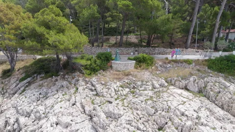 Cinematic Pullback of Goodbye Statue and Island Coast Stock Footage 313808788