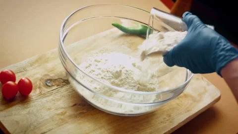 Cinematic raw pide prepared for baking in warm kitchen light in tabletop, 4K Stock Footage 341113604