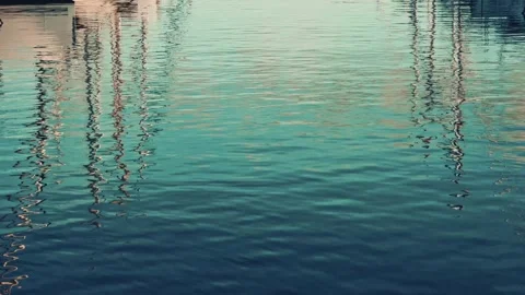 Cinematic reflection of sailboat masts on calm turquoise water surface in q.. Stock Footage 339120726