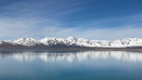 Cinematic Reflection of Snow Capped Peaks on Still Water 動画素材 334707139