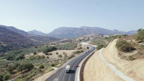 Cinematic road landscape. Epic view on the curve road in mountains, moving cars. Stock Footage 168250281