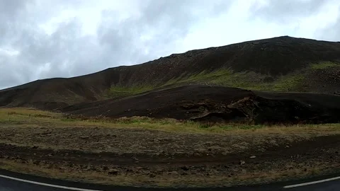 Cinematic road trip view of dramatic lava hills and red cabin, Iceland POV Stock Footage 335000756