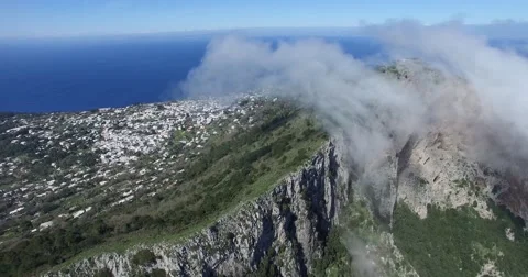 CINEMATIC ROLLING CLOUDS OVER STEEP ROCK CLIFFS IN CAPRI ISLAND Stock Footage 63313711