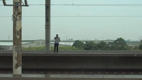 Cinematic scene. The fast train crosses the station suddenly in China Stock Footage 117745727
