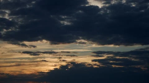 Cinematic Scene Featuring Dark Storm Clouds Beneath Vibrant Sunset With Layered Stock Footage 323771218