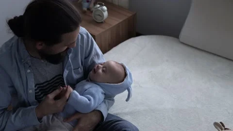 Cinematic Shot Bearded Long-haired Young Neo Father Rocking Smiling Newborn Baby Stock Footage 167952178