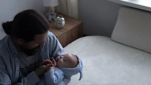 Cinematic Shot Bearded Long-haired Young Neo Father Holds Hand Of Newborn Baby Video stock 167978568