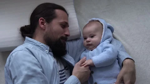 Cinematic Shot Bearded Long-haired Young Neo Father Smiling With Newborn Baby In Stock Footage 167978699