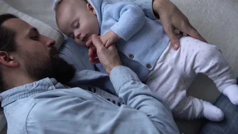Cinematic Shot Bearded Long-haired Young Neo Father Strokes Hand Newborn Baby In Stock Footage 198552913