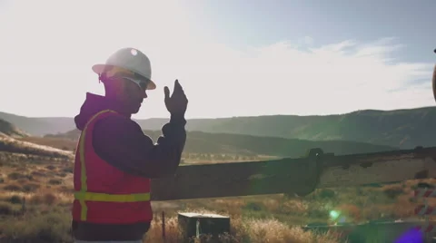 Cinematic shot of construction worker directing concrete truck Stock Footage 55150718