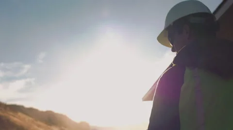 Cinematic shot of construction worker standing in sunshine Stock Footage 55156230