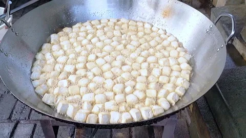 Cinematic shot. The cooking process of Crispy Pong Tofu in deep frying hot pan Stock Footage 303643764