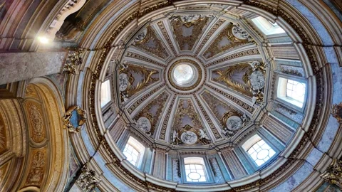 Cinematic shot of the decorated dome interior in Santissimo Nome di Maria church Stock Footage 338184823