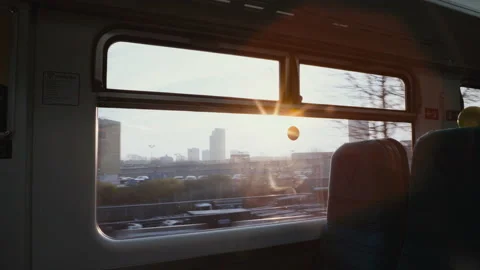 Cinematic shot looking out window on train at sunrise. Morning commute Video stock 227114358