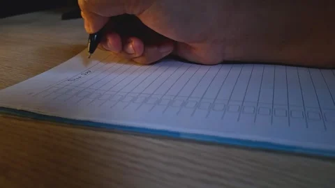 Cinematic Shot with Low Angle Hand Writing in Notebook at Night Moody Lightin Stock Footage 332893407