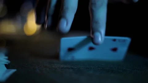 Cinematic shot of a magician's hands doing card tricks in dark background. Stock Footage 167094380