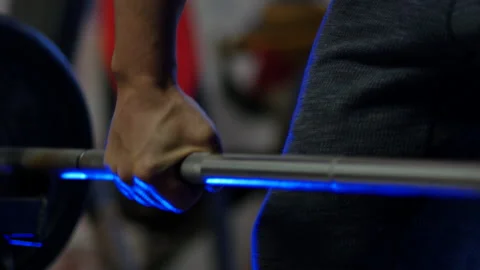 Cinematic shot of man's hand doing "rowing" musculation exercise with blue Stock Footage 142143102