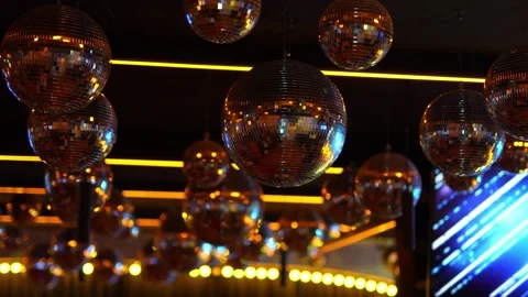 Cinematic shot of multiple hanging disco balls in a dark nightclub. Stock Footage 329437801