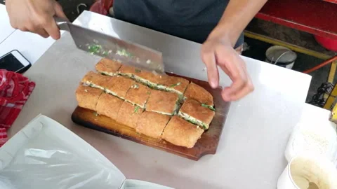 Cinematic shot. The serving process of Martabak Telor Stock Footage 246375219