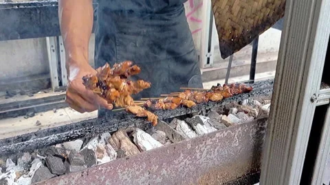Cinematic shot of the serving process of satay cooked over charcoal or a grill Stock Footage 307579173
