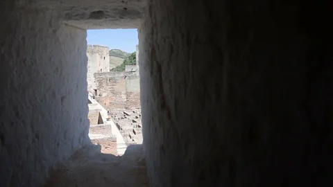 Cinematic shot through window from top of Andalucia Alhambra tower Stock Footage 74479614