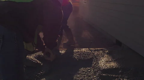 Cinematic shot of two men spreading concrete Stock Footage 55158857