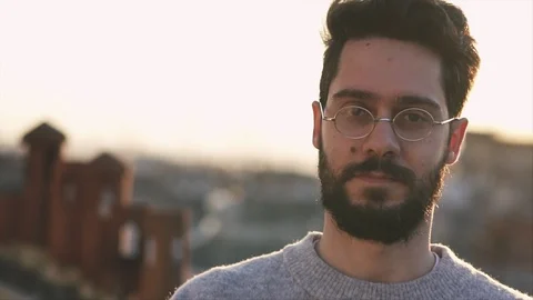 Cinematic Shot of Young Man, Camera follows around him, On Rooftop of a build Видео 106636957