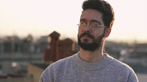 Cinematic Shot of Young Man, Camera follows around him, On Rooftop of a build Stock Footage 106636971