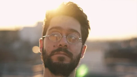 Cinematic Shot of Young Man, Camera follows around him, On Rooftop of a build Video stock 106636994