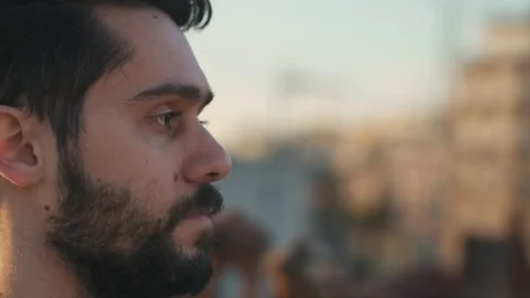 Cinematic Shot of Young Man, Camera follows around him, On Rooftop of a build Stock Footage 106637819