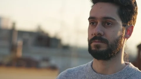 Cinematic Shot of Young Man, Camera follows around him, On Rooftop of a build Video stock 106637833