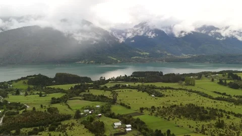 Cinematic Side Drone Flight and Ascent Over Valley Toward Fjord and Cloudy Mount 库存影片 333123151