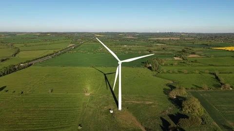 Cinematic side drone flyby of wind turbine over countryside fields Stock Footage 333936014