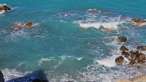 Cinematic Side-Panning Shot of Waves Crashing Against Rocks in Skiathos Stock Footage 340403343