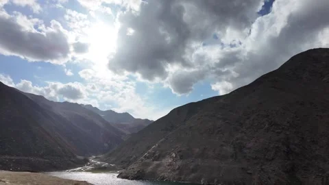 Cinematic Side View of a Deep, Dark Green Lake, Framed by Dark Mountains Und Stock Footage 289192438