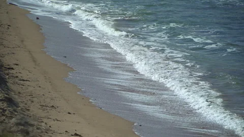 Cinematic Side View of Stunning Tide Rolling onto Beach Stock Footage 314320649