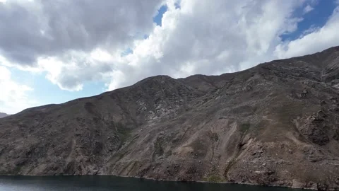 A Cinematic Side View,Road, Overlooking a Deeply Dark Green Lake. Dark Mount Stock Footage 289190158