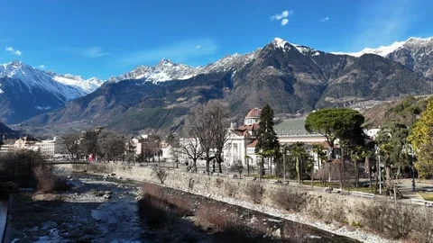 Cinematic Sideways Drone Flight Over Sunny Alpine Village with Dramatic Stock Footage 331746502