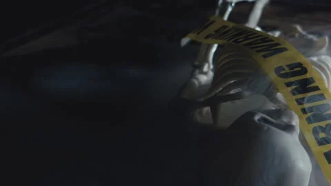 Cinematic Skeleton Wrapped in Warning Tape on Ouija Board Stock-Footage 346456534