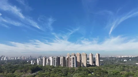 Cinematic slow forward drone flight approaching a vast skyline of high-rise Vídeo Stock 339104474
