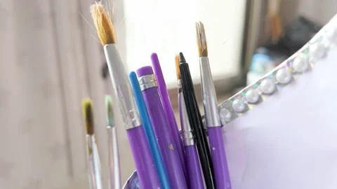 Cinematic slow motion 4k shot of painting brushes in stand 動画素材 343621326