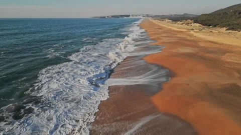 Cinematic Slow Motion Aerial Pullback Revealing a Vast Sandy Coastline Video stock 334939021