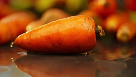 Cinematic Slow Motion of Carrot Falling on Table Vídeos de archivo 296362248