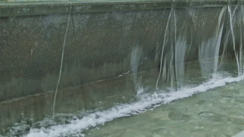 Cinematic slow motion close-up of urban water fountain cascade Stock Footage 345660241
