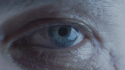 Cinematic slow motion eye close up, loop. Macro. Pale blue iris. Wrinkled skin Stock Footage 246002414